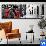 Leinwandbild Rotes Fahrrad In Gasse Panorama Produktvorschau mit dem Bild Rotes Fahrrad in Gasse im Format Panorama.