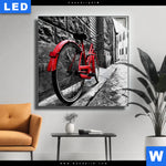 Leuchtbild Rotes Fahrrad In Gasse Quadrat Produktvorschau mit dem Bild Rotes Fahrrad in Gasse im Format Quadrat.