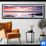 Poster Sonnenaufgang Am Strand Mit Felsen Panorama Produktvorschau mit dem Bild Sonnenaufgang am Strand mit Felsen im Format Panorama.