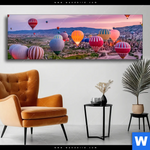 Wechselmotiv Heissluftballons Im Sonnenuntergang Panorama Produktvorschau mit dem Bild Heißluftballons im Sonnenuntergang im Format Panorama.