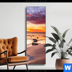 Wechselmotiv Sonnenuntergang Am Strand Mit Felsen Schmal Produktvorschau mit dem Bild Sonnenuntergang am Strand mit Felsen im Format Schmal.
