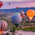 Wechselmotiv Heißluftballons im Sonnenuntergang Panorama Zoom wandbild.com